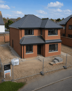 New build home near external completion with brickwork and dark windows
